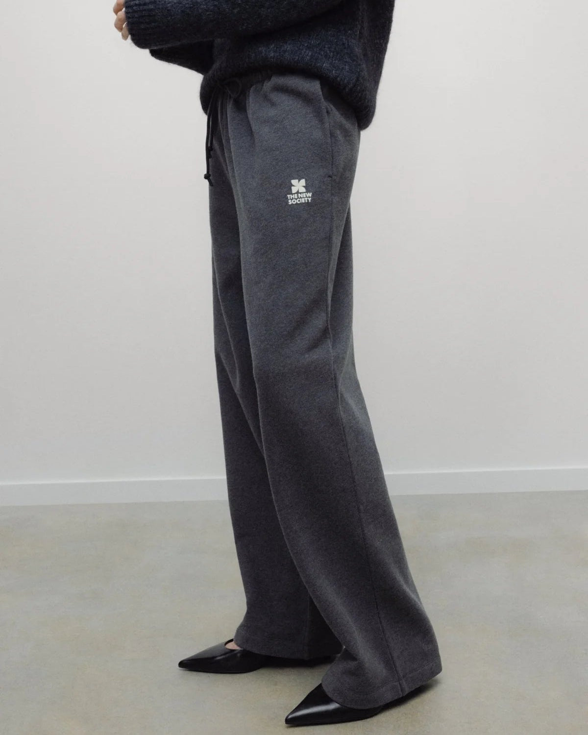 The New Society TNS Logo Woman Jogging