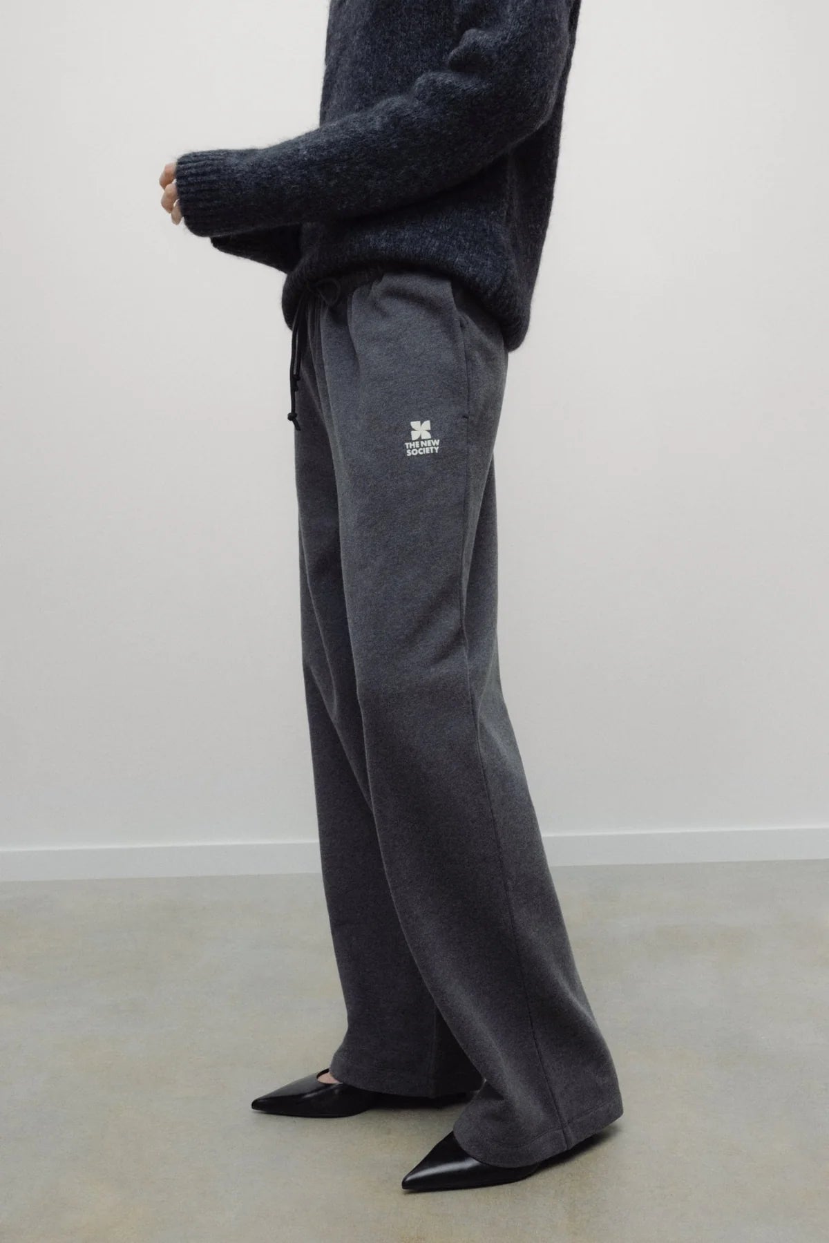 The New Society TNS Logo Woman Jogging